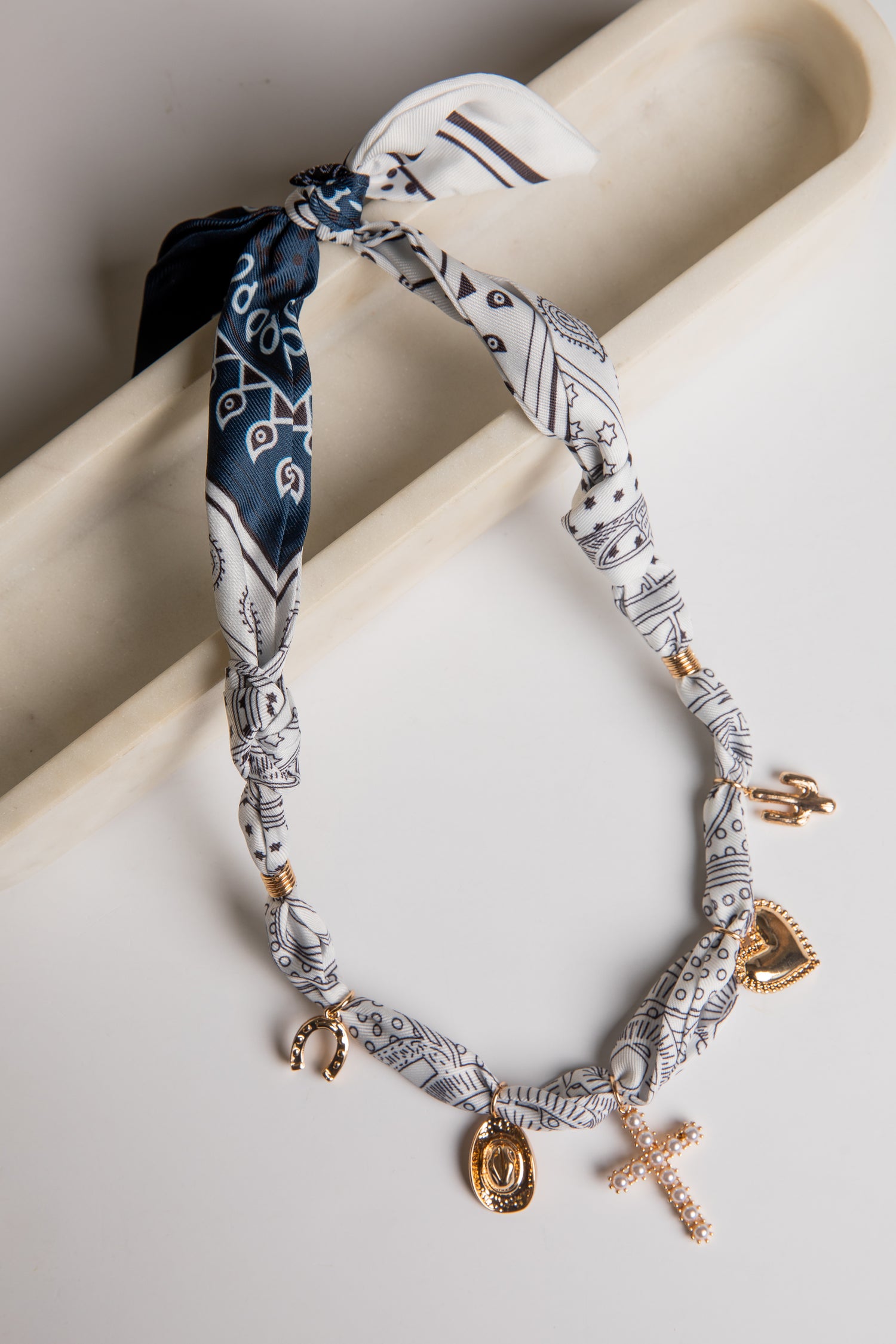 Necklace with charms on a white surface
