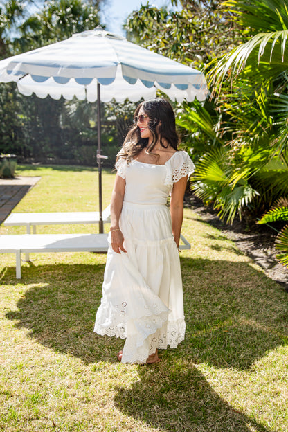 White flowy maxi skirt styled in garden