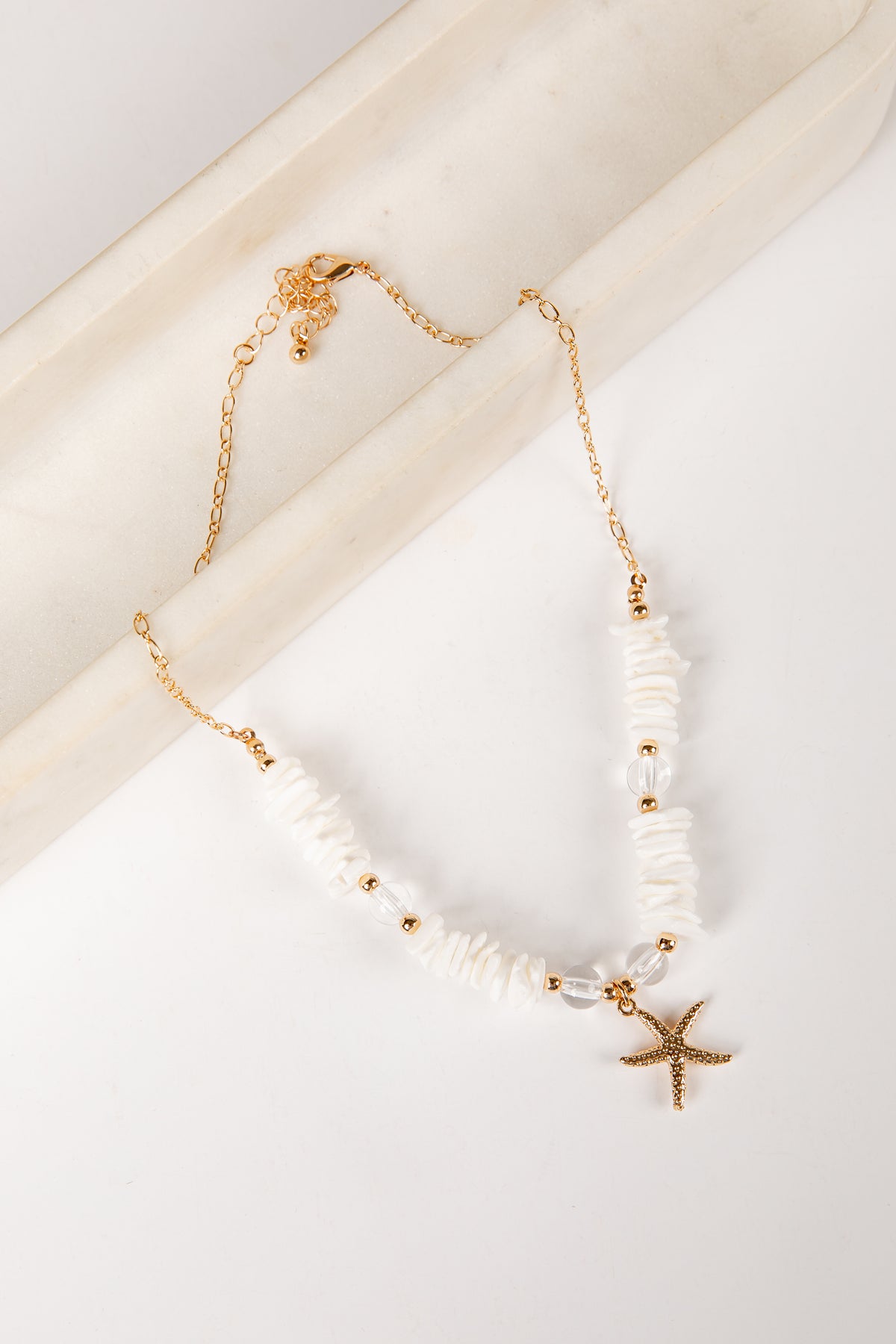 Necklace with starfish charm on a light background
