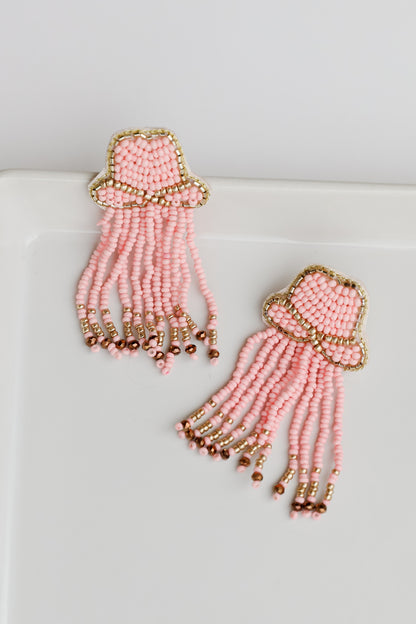 flat lay of pink Cowgirl Hat Beaded Fringe Earrings